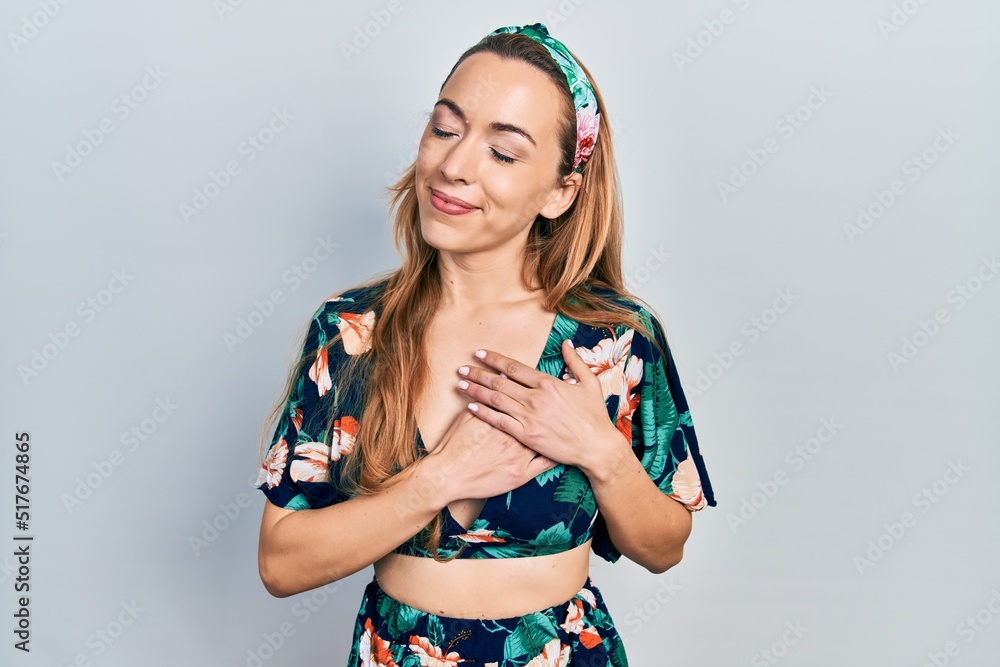 Young caucasian woman wearing casual clothes smiling with hands on chest, eyes closed with grateful gesture on face. health concept. Young caucasian woman wearing casual clothes smiling with hands on chest, eyes closed with grateful gesture on face. health concept.