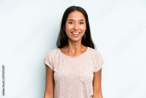 hispanic pretty woman looking happy and pleasantly surprised, excited with a fascinated and shocked expression
