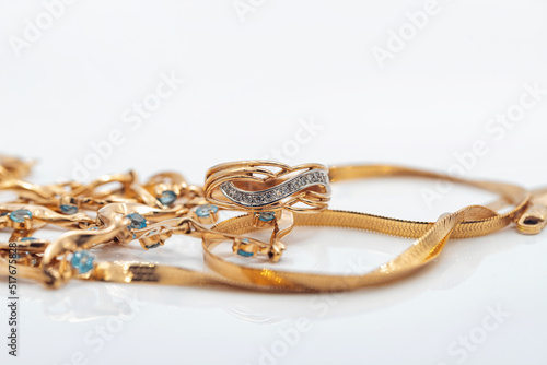 A gold chain with a pendant and a Topaz ring