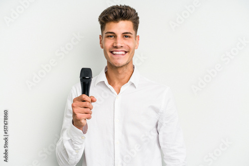 Young singer caucasian man isolated on white background happy, smiling and cheerful. © Asier