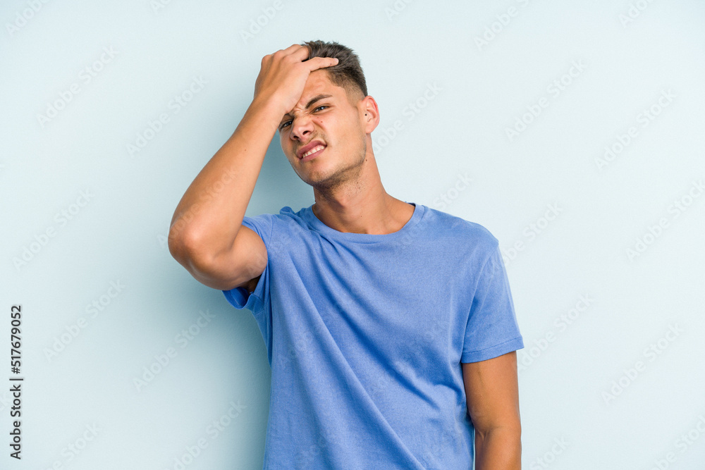 Young caucasian man isolated on blue background forgetting something, slapping forehead with palm and closing eyes. Young caucasian man isolated on blue background forgetting something, slapping forehead with palm and closing eyes.