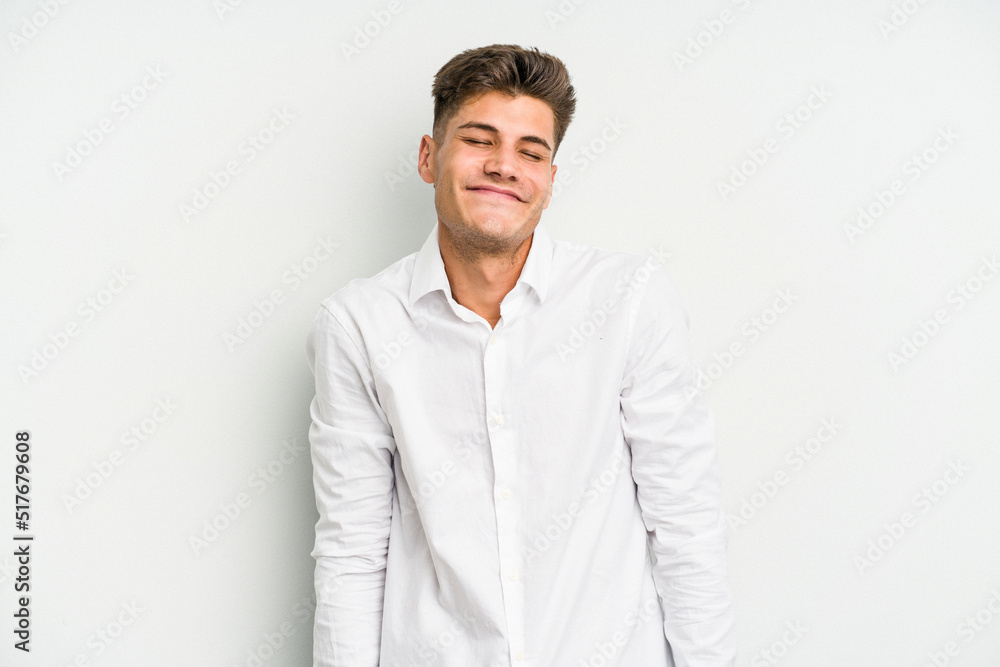 Young caucasian man isolated on white background laughs and closes eyes, feels relaxed and happy. Young caucasian man isolated on white background laughs and closes eyes, feels relaxed and happy.