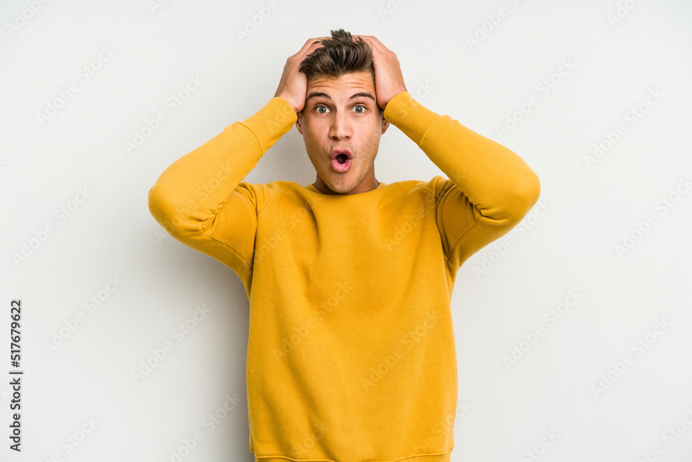 Young caucasian man isolated on white background surprised and shocked. Young caucasian man isolated on white background surprised and shocked.