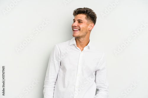 Young caucasian man isolated on white background relaxed and happy laughing, neck stretched showing teeth. © Asier