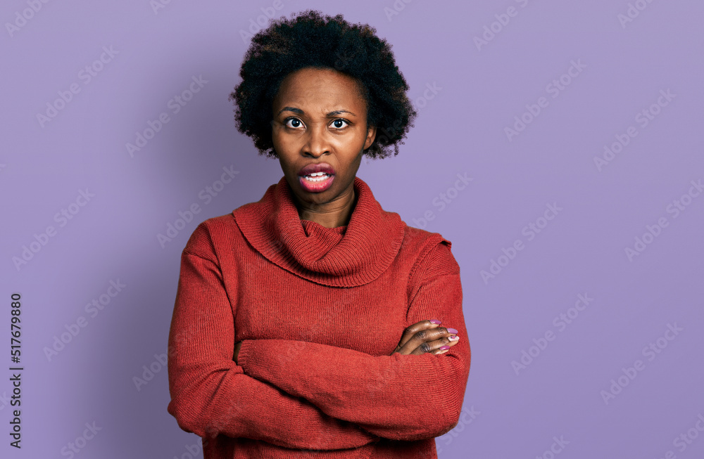 African american woman with afro hair with arms crossed gesture in shock face, looking skeptical and sarcastic, surprised with open mouth African american woman with afro hair with arms crossed gesture in shock face, looking skeptical and sarcastic, surprised with open mouth