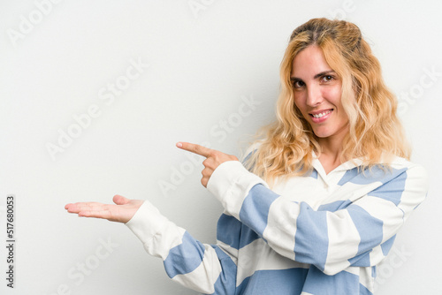 Young caucasian woman isolated on white background excited holding a copy space on palm.