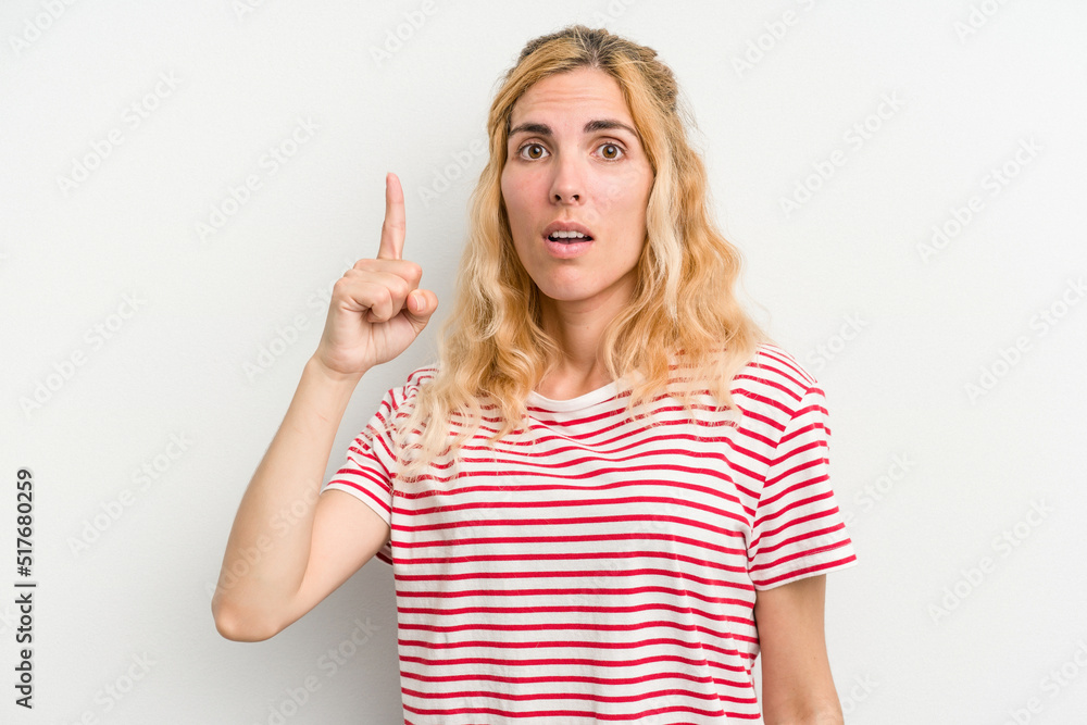 Young caucasian woman isolated on white background pointing upside with opened mouth. Young caucasian woman isolated on white background pointing upside with opened mouth.