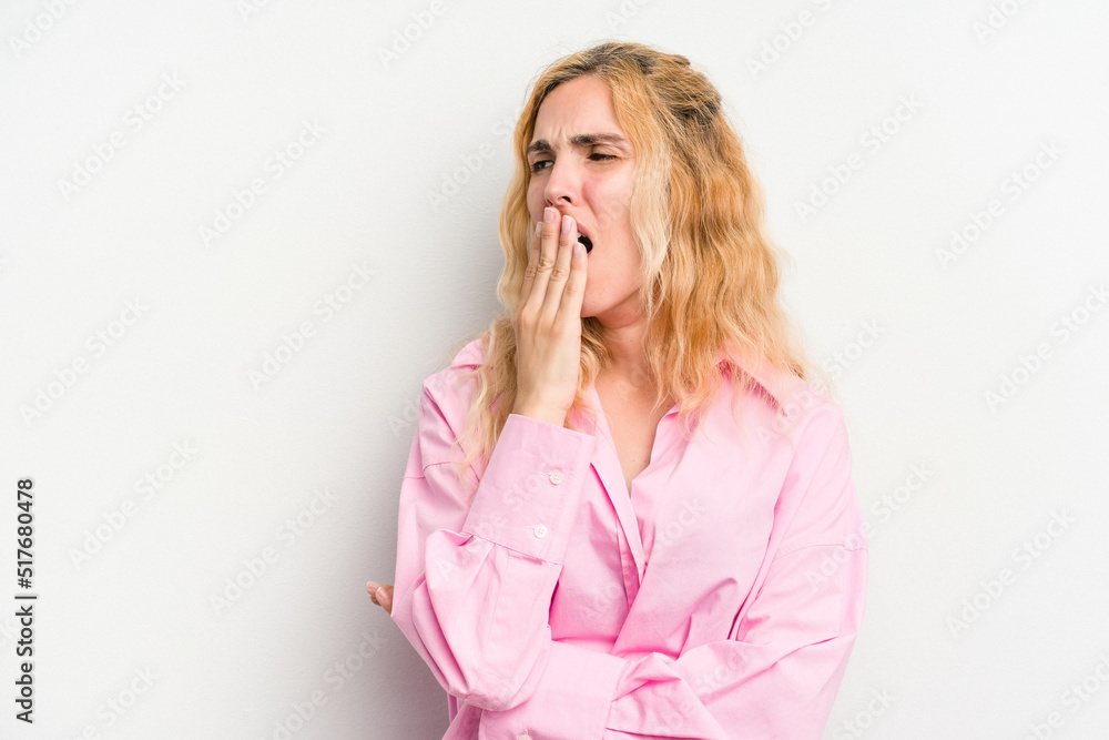 Young caucasian woman isolated on white background yawning showing a tired gesture covering mouth with hand.
