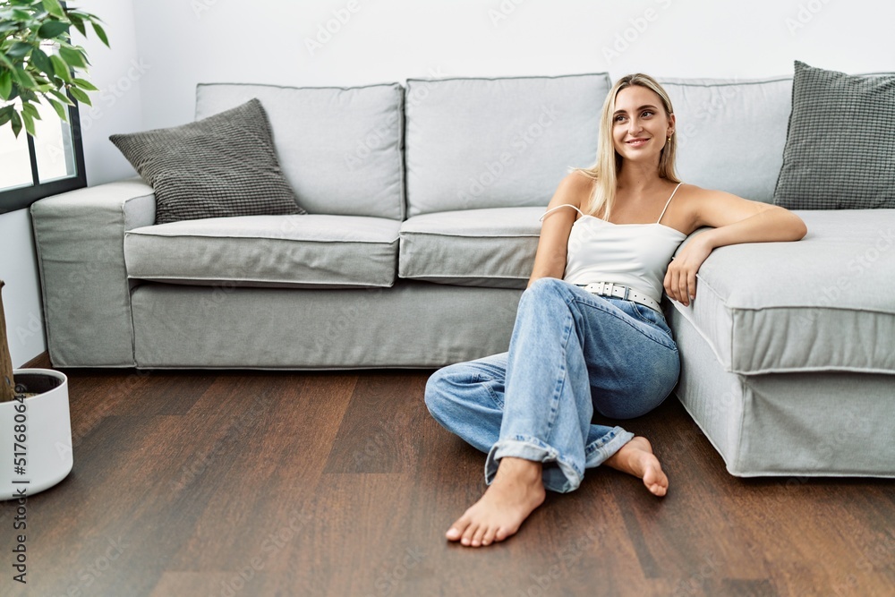Young blonde woman smiling confident sitting on the floor at home Young blonde woman smiling confident sitting on the floor at home