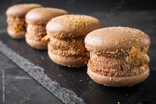 colored macaroons on a dark stone background