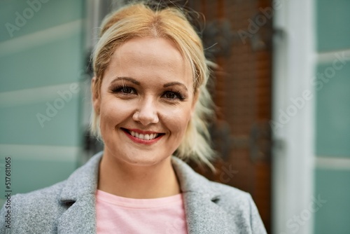 Free Download Young blonde businesswoman smiling happy standing at the city. - GFXLoad