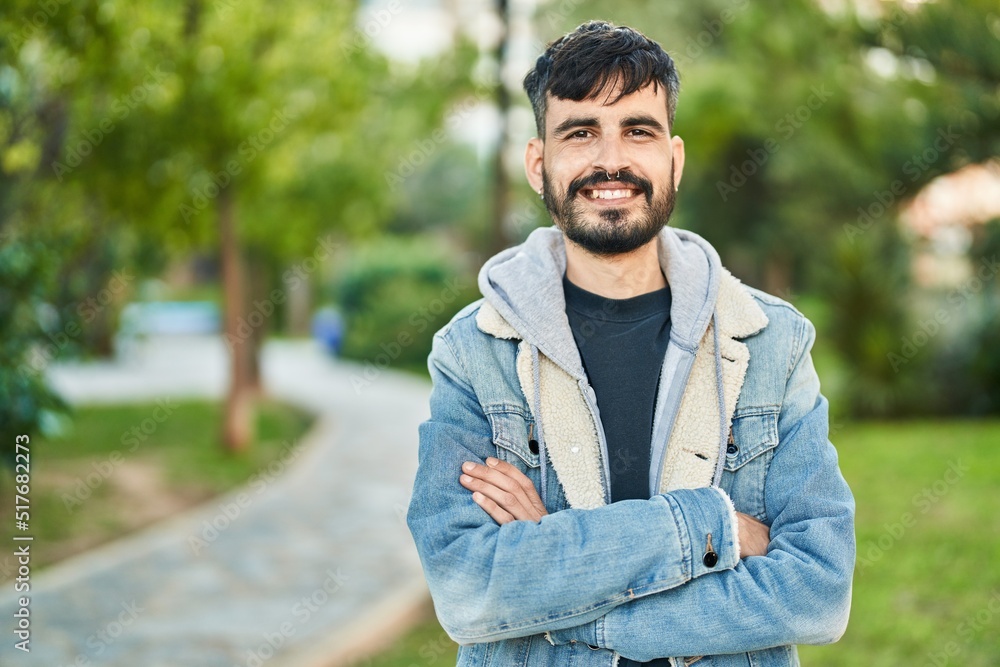 Young hispanic man smiling confident standing with arms crossed gesture at park Young hispanic man smiling confident standing with arms crossed gesture at park
