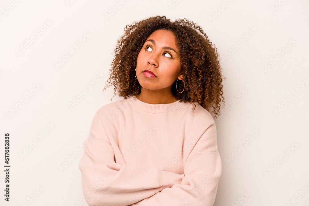 Young African American woman isolated on white background dreaming of achieving goals and purposes Young African American woman isolated on white background dreaming of achieving goals and purposes