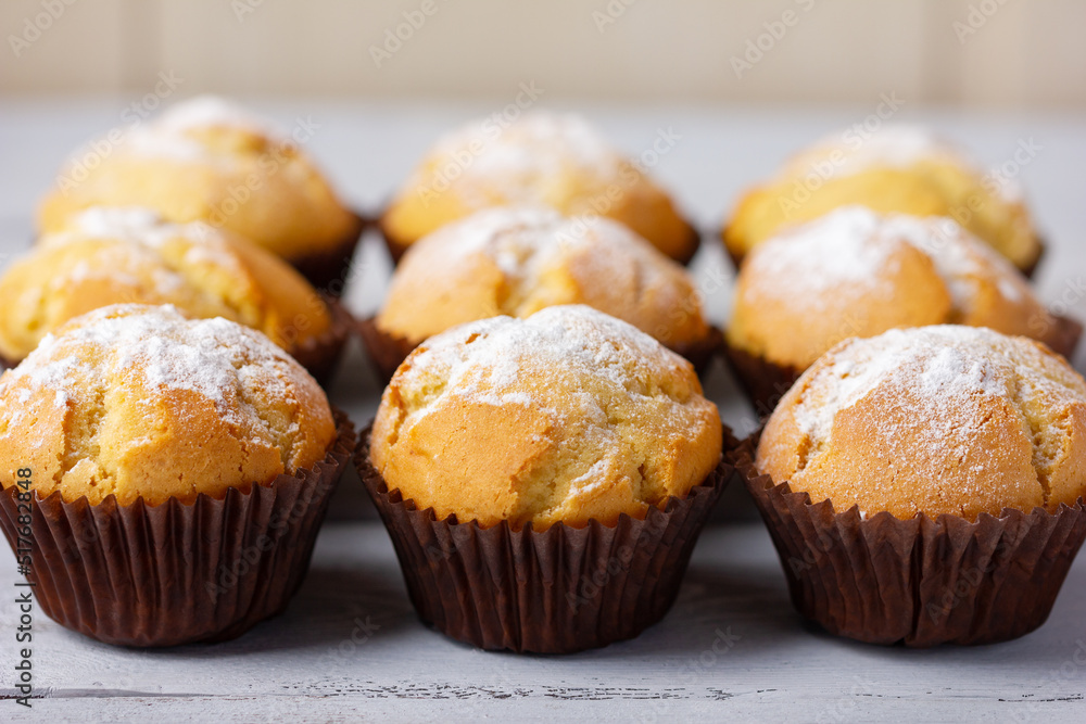 Freshly baked, homemade cupcake in muffin tin with paper liner.