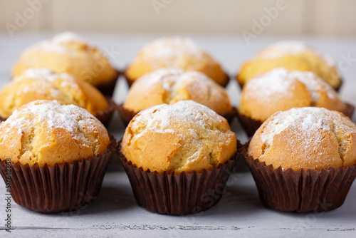 Freshly baked, homemade cupcake in muffin tin with paper liner.