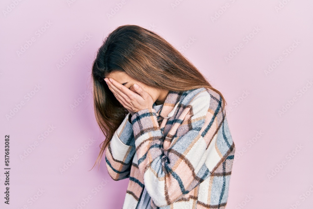 Young caucasian girl wearing casual clothes with sad expression covering face with hands while crying. depression concept. Young caucasian girl wearing casual clothes with sad expression covering face with hands while crying. depression concept.