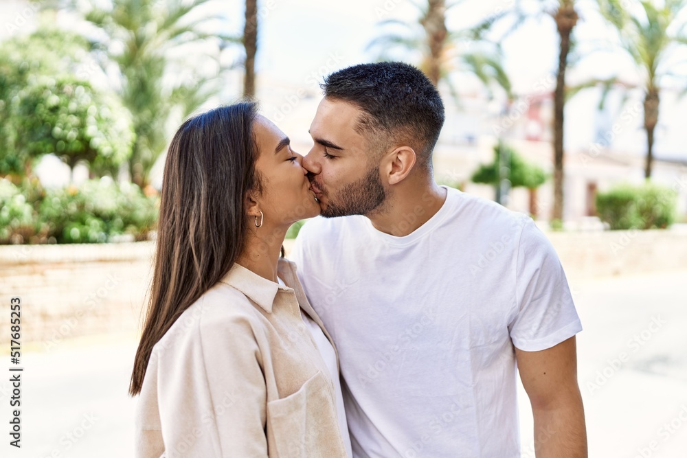 Young latin couple kissing and hugging standing at the city. Young latin couple kissing and hugging standing at the city.