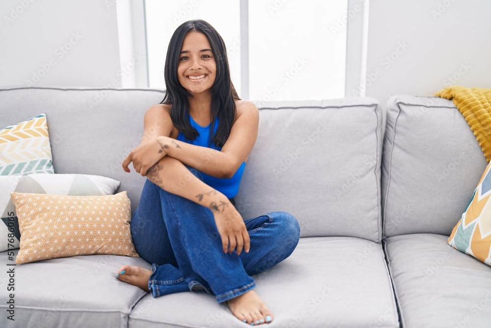 Young hispanic woman smiling confident sitting on sofa at home Young hispanic woman smiling confident sitting on sofa at home