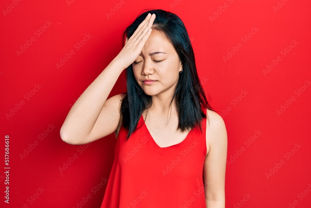 Young chinese girl wearing casual clothes surprised with hand on head for mistake, remember error. forgot, bad memory concept. Young chinese girl wearing casual clothes surprised with hand on head for mistake, remember error. forgot, bad memory concept.