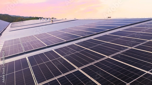 Photovoltaic solar panels mounted on building roof for producing clean ecological electricity at sunset. Production of renewable energy concept. 