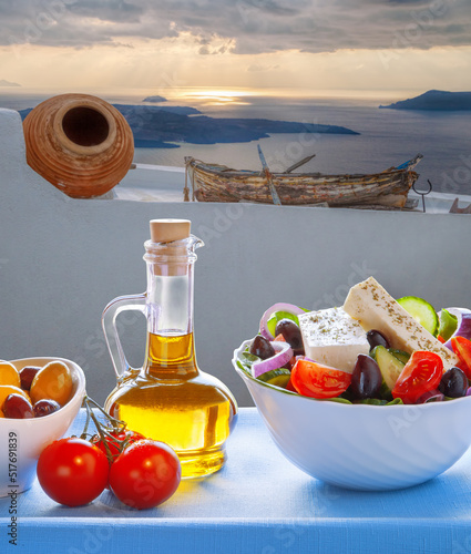 Greek salad against fishing boat in Thira town on Santorini island in Greece