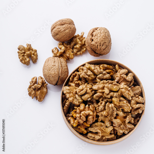 dried walnuts on a white acrylic background