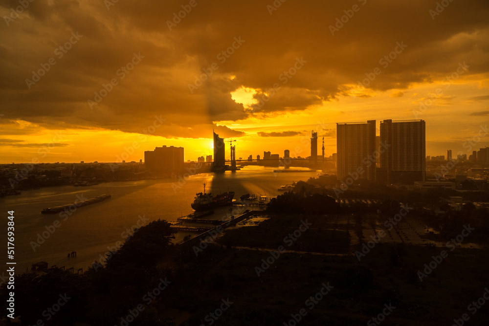 Sunset with raining over Chao Phraya River in Bangkok, Thailand