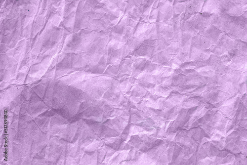 High detail of the abstract texture of the packaging paper. The texture of crumpled purple craft paper. Crumpled purple paper background top view. The texture of crumpled purple paper. Space for text.