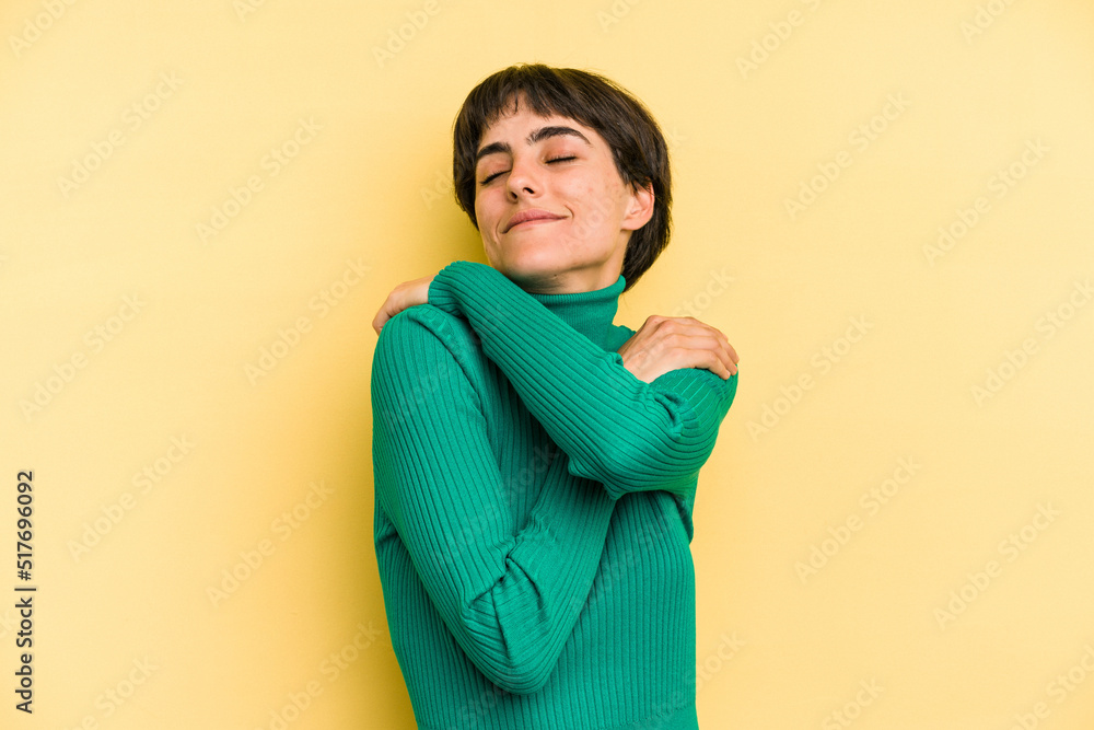 Young caucasian woman with a short hair cut isolated hugs, smiling carefree and happy. Young caucasian woman with a short hair cut isolated hugs, smiling carefree and happy.