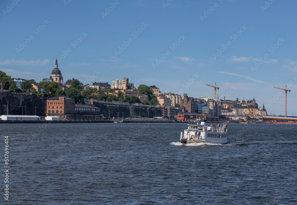 Old harbor ferry  MS Kung Ring passing the island Djurgården a sunny for the archipelago summer day in Stockholm