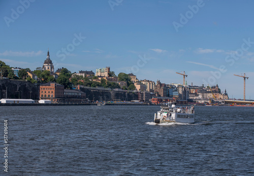 Old harbor ferry MS Kung Ring passing the island Djurgården a sunny for the archipelago summer day in Stockholm