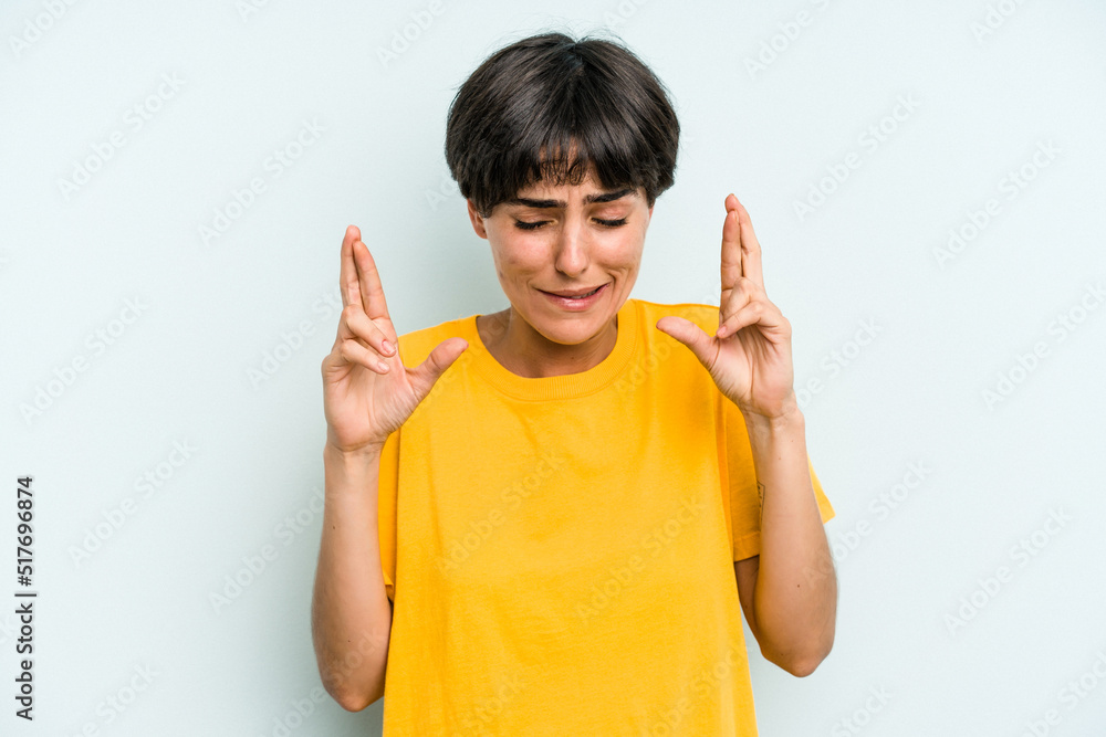 Young caucasian woman with a short hair cut isolated crossing fingers for having luck Young caucasian woman with a short hair cut isolated crossing fingers for having luck
