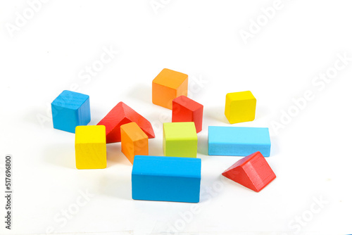 Different colorful shapes of wooden blocks on white background. Geometric shapes in different colors,