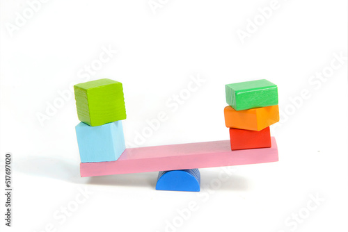 toys seesaw wooden blocks, teeter totter on white background weight cube, swing with heavy and light idea photo