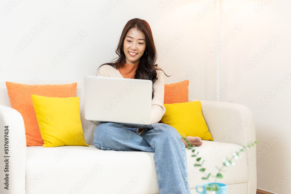 Happy young woman using smart phone for shopping online at home. Lifestyle relax and chill drinking coffee in living room. Lifestyle Concept Happy young woman using smart phone for shopping online at home. Lifestyle relax and chill drinking coffee in living room. Lifestyle Concept
