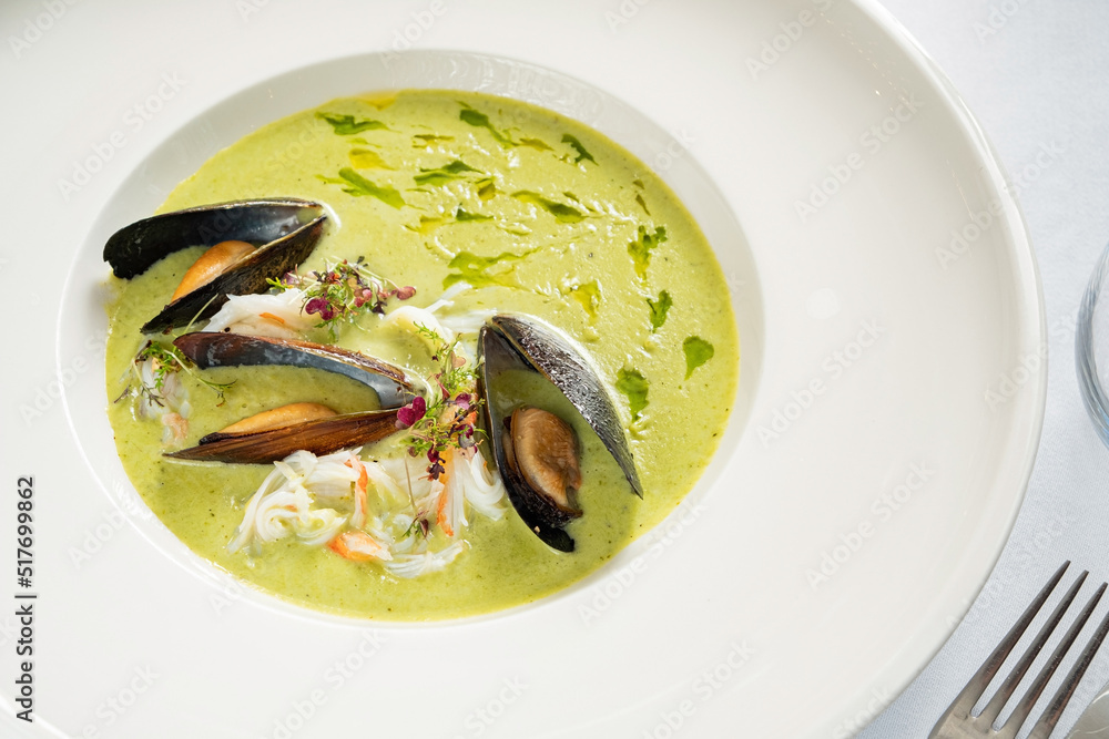 cream soup with mussels and herbs