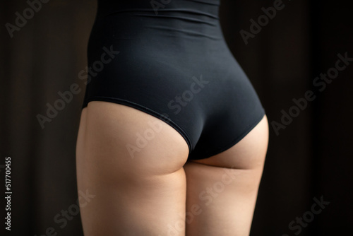 Slender round female buttocks