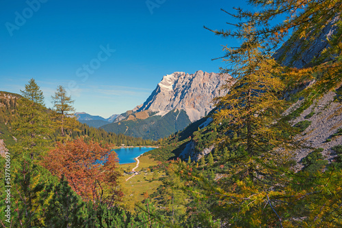Fototapeta Naklejka Na Ścianę i Meble -  idyllic alpine landscape with lake view Seebensee, larch trees and forest in autumn