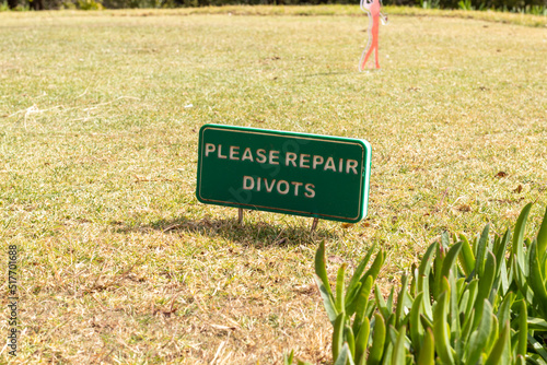 Фотография Repair divots sign at a golf course