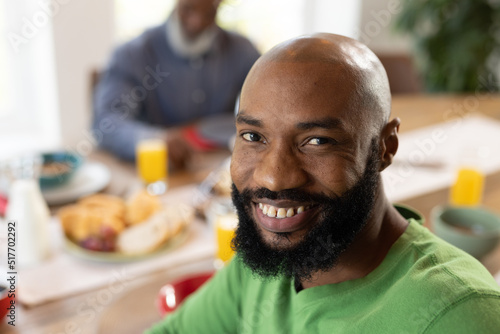 Image of happy african american man smiling at camera