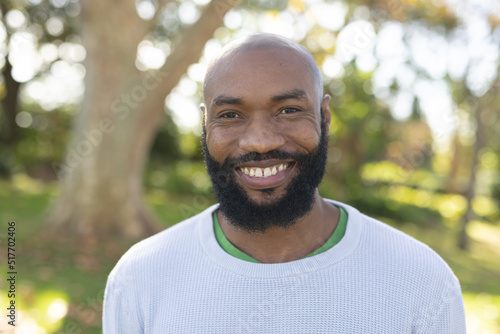 Image of happy african american man smiling at camera