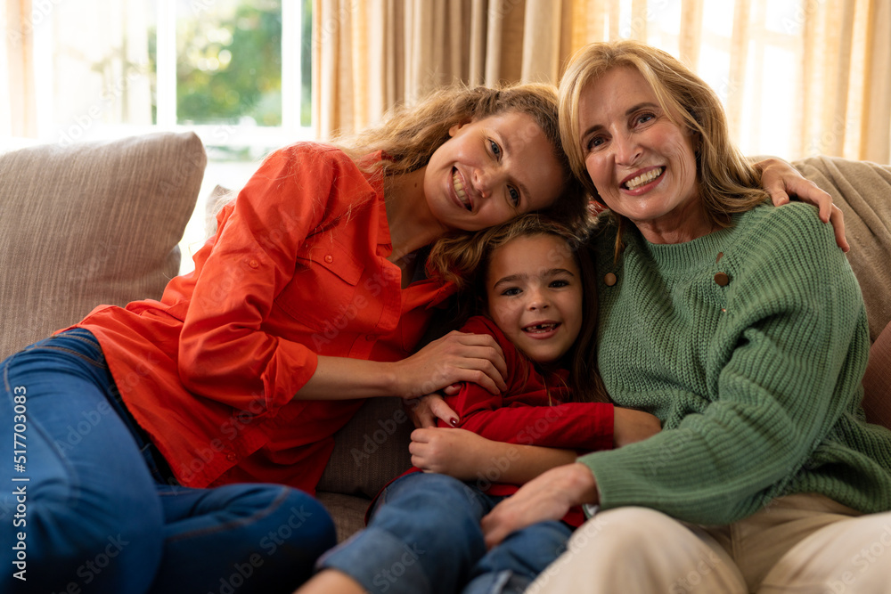Image of happy three generation caucasian women sitting on sofa and smiling Image of happy three generation caucasian women sitting on sofa and smiling