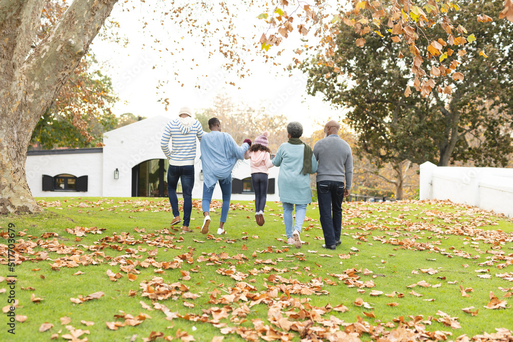 Naklejka premium Image of back view of multi generation african american family having fun outdoors in autumn