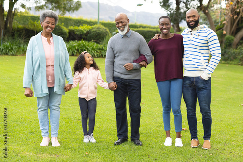 Image of happy multi generation african american family posing together outdoors
