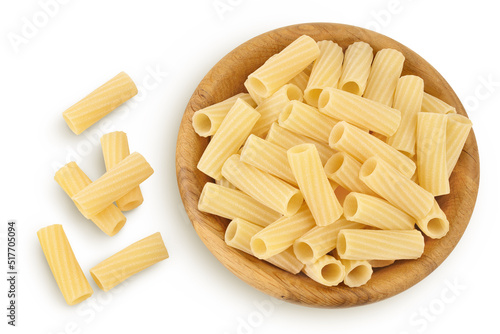 raw italian tortiglioni pasta in wooden bowl isolated on white background with full depth of field. Top view. Flat lay