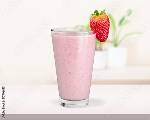 Tasty iced pink milk. Cold sweet drink mix with milk and ice in glass