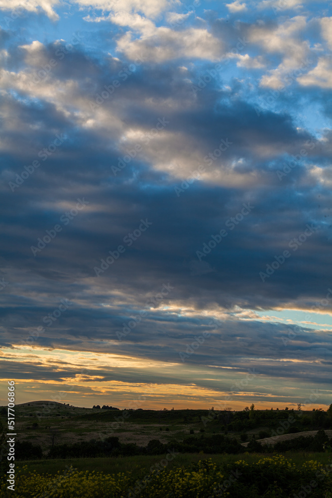 A sunny sunset.Dramatic sunset over the horizon. Above the meadows. Red sky background. beautiful rays of the sun.Landscape A sunny sunset.Dramatic sunset over the horizon. Above the meadows. Red sky background. beautiful rays of the sun.Landscape
