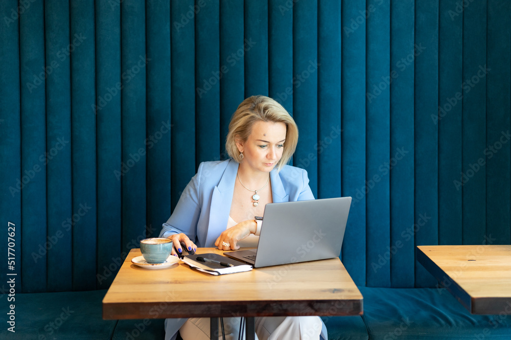 business woman. face beautiful caucasian young or mature professional career woman boss in business suit working on laptop. modern women entrepreneur working in restaurant and cafe small business business woman. face beautiful caucasian young or mature professional career woman boss in business suit working on laptop. modern women entrepreneur working in restaurant and cafe small business