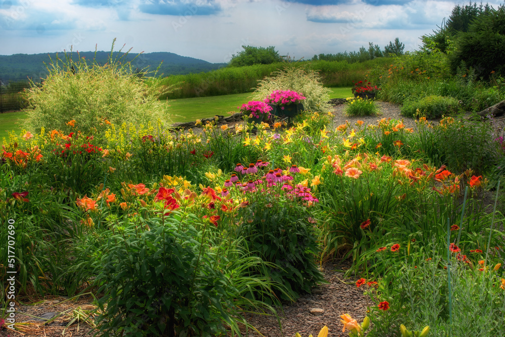 Obraz premium A Beautifully landscaped home garden in NE PA. Summer comes to life in colors of the rainbow in this family Garden.