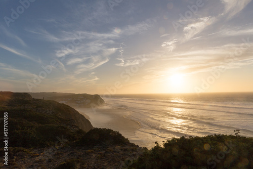 Sunset over the Atlantic Ocean. Waves are crashing on the cliffs of Portugal